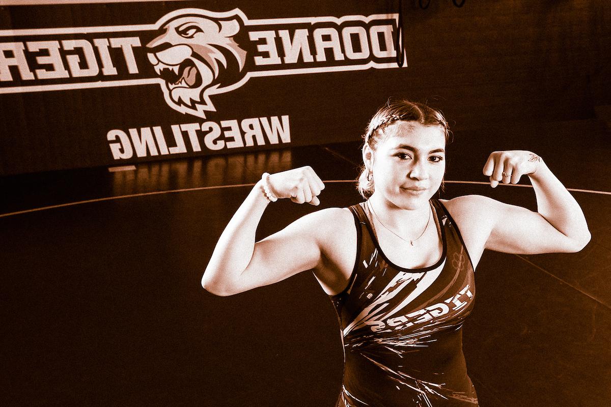 Cristelle罗德里格斯 flexes on the mats in Butler Gymnasium during a photoshoot. 