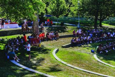 Students enjoy a sunny day in Cassel Theatre. 